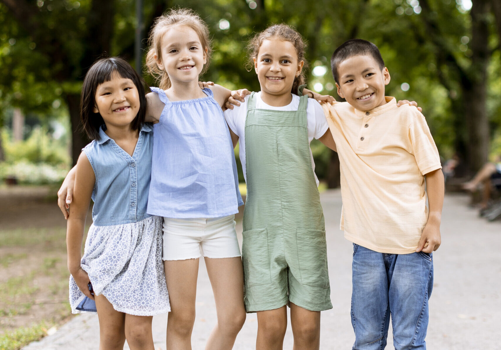 Group of cute asian and caucasian kids having fun in the park